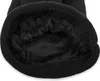 A close-up view of the inside of a black knitted beanie, showing the soft fleece lining. Produktbild-Vorschau