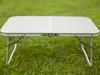 A foldable table is set up on a grassy lawn. Anteprima dell’immagine prodotto