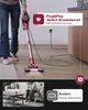 A person is using a red vacuum cleaner, which is shown connected to an electrical outlet. A comparison with a white vacuum cleaner with low battery is presented in a separate panel. Produktbild-Vorschau