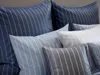 A close-up view of several striped pillows. Produktbild-Vorschau