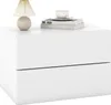 A white nightstand with two drawers, a lamp, and books on top. Podgląd zdjęcia produktu