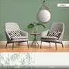 Two chairs and a small table with a plant in a room with green walls. Produktbild-Vorschau