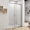 A modern bathroom with a glass shower enclosure against a white brick wall. Produktbild-Vorschau