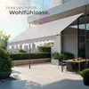 A modern balcony with a retractable awning, outdoor furniture, and a city skyline in the background. Náhled obrázku produktu