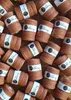 A collection of spools of macrame cord, arranged in a scattered pattern on a wooden surface. Podgląd zdjęcia produktu