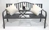 A dark gray metal garden bench with two white cushions and a small table with two teacups and a potted plant. Produktbild-Vorschau