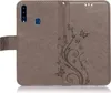 A gray flip case for a smartphone, decorated with a floral and butterfly pattern. Produktbild-Vorschau