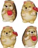 Four ceramic hedgehog figurines, each holding either a red apple or a red mushroom, arranged in a two-by-two grid on a white background. Náhľad obrázku produktu