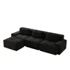 A modular L-shaped sofa with an ottoman, shown from a side-angle. Produktbild-Vorschau