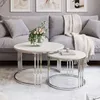 A living room scene with a sofa, coffee tables, and artwork. Náhľad obrázku produktu