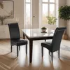 A dining room scene with a marble-topped table and two black chairs. Produktbild-Vorschau