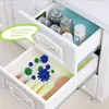 An open kitchen drawer showing items inside, with a graphic overlay representing bacteria. Produktbild-Vorschau