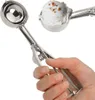 A hand holding a stainless steel ice cream scoop with a scoop of ice cream in it. Náhľad obrázku produktu