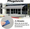 A gray awning is installed in front of a building entrance, with a close-up inset showing a hand wiping water droplets off a fabric surface. Produktbild-Vorschau