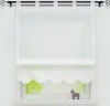 A white sheer curtain with lace trim hangs in front of a window with a blurry green view outside. A small decorative horse figurine sits on the windowsill. Produktbild-Vorschau