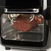 A close-up view of a raw, seasoned piece of meat inside an air fryer oven. Produktbild-Vorschau