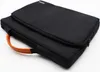 A black laptop bag with an orange handle is shown against a white background. Náhľad obrázku produktu