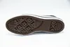 The sole of a black Converse shoe is shown against a white background. Voir les images du produit
