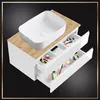 A white bathroom vanity with a sink on top and open drawers filled with makeup and toiletries. Náhľad obrázku produktu