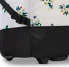 A close-up view of the bottom section of a wheeled bag with a floral pattern. Voir les images du produit