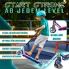 A young boy is riding a stunt scooter in a skate park. Produktbild-Vorschau
