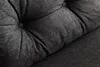 A close-up view of the tufted dark gray fabric of a sofa cushion. Náhled obrázku produktu
