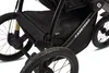 A close-up view of the wheels and frame of a black stroller. Náhled obrázku produktu