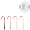 Four candy cane lawn stakes are arranged in a row on a white background, with a small white box displaying text and numbered options above them. Voir les images du produit