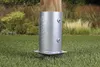 A metal post anchor is installed in a grassy lawn next to a wooden post. Produktbild-Vorschau