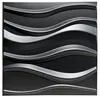 A close-up view of a black textured wall panel with raised, wavy, silver-colored lines. Produktbild-Vorschau