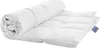 A white duvet rolled up on one side and spread out on the other, on a white background.