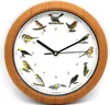 A round wall clock with a wooden frame, featuring illustrations of different birds at each hour mark. Produktbild-Vorschau