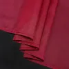 A close-up of folded burgundy fabric, likely a curtain or drapery, against a black background. Produktbild-Vorschau