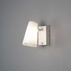 A white wall lamp with a motion sensor is mounted on a gray wall. Produktbild-Vorschau