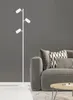 A modern living room scene with a floor lamp and a sofa. Anteprima dell’immagine prodotto