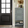 A shoe cabinet is placed next to a dark gray door in a hallway. Podgląd zdjęcia produktu