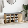 A shoe bench with storage compartments and a cushioned top, placed in a hallway or entryway next to a potted plant and a mirror. Anteprima dell’immagine prodotto
