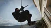 A person rappelling down a building. Produktbild-Vorschau