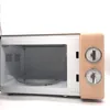 An open microwave oven with a glass turntable inside, set against a white background. Produktbild-Vorschau