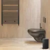 A modern bathroom with a black toilet, black trash can, and a black towel warmer against a wood-paneled wall. Náhľad obrázku produktu