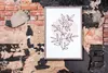 A framed print with a botanical illustration is displayed on a distressed brick wall. Produktbild-Vorschau