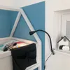 A close-up view of a bedside lamp attached to a child's bed frame, with a blue wall in the background. Anteprima dell’immagine prodotto