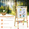 A wooden easel with drawings on it, set against a backdrop of a sunlit forest. Produktbild-Vorschau