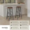 Two bar stools are placed in a modern kitchen setting, with a countertop and sink visible in the background. Náhled obrázku produktu