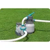 A sand filter pump system for a swimming pool is set up on a grassy lawn. Produktbild-Vorschau