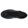 A top-down view of a black leather sneaker. Voir les images du produit