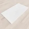 A white shower tray is placed on a light wooden floor. Produktbild-Vorschau