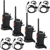 A set of four black Retevis RT24 Plus walkie-talkies with orange accents, each in a charging cradle, along with two headsets. The items are arranged on a white background. Podgląd zdjęcia produktu