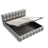 A grey upholstered bed frame with the mattress support slats lifted to reveal the storage compartment underneath. Anteprima dell’immagine prodotto