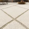 A close-up view of a textured rug with a geometric pattern. Anteprima dell’immagine prodotto